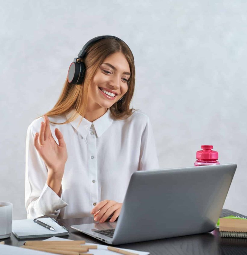 woman-waving-and-talking-during-online-education-on-laptop.jpg